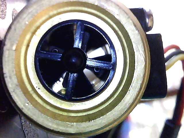 A flow counter, seen through the pipe showing the impellers